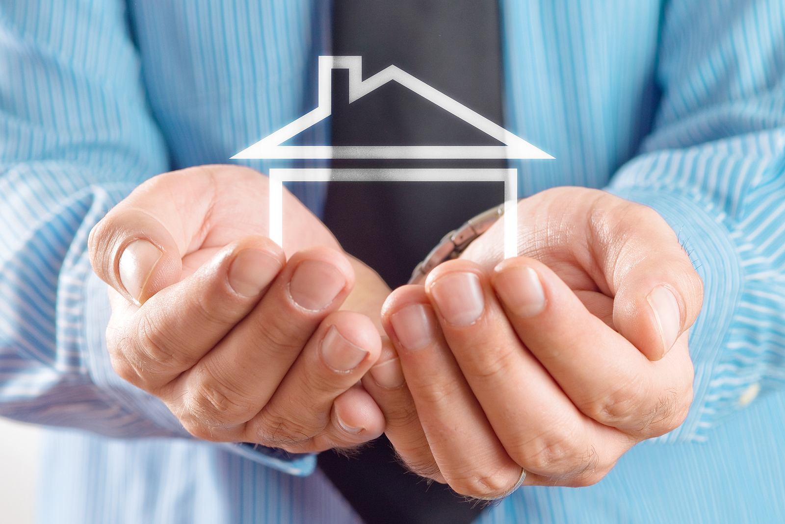 House in hands. real estate agent holding house in cupped hands. House selling or home insurance concept.