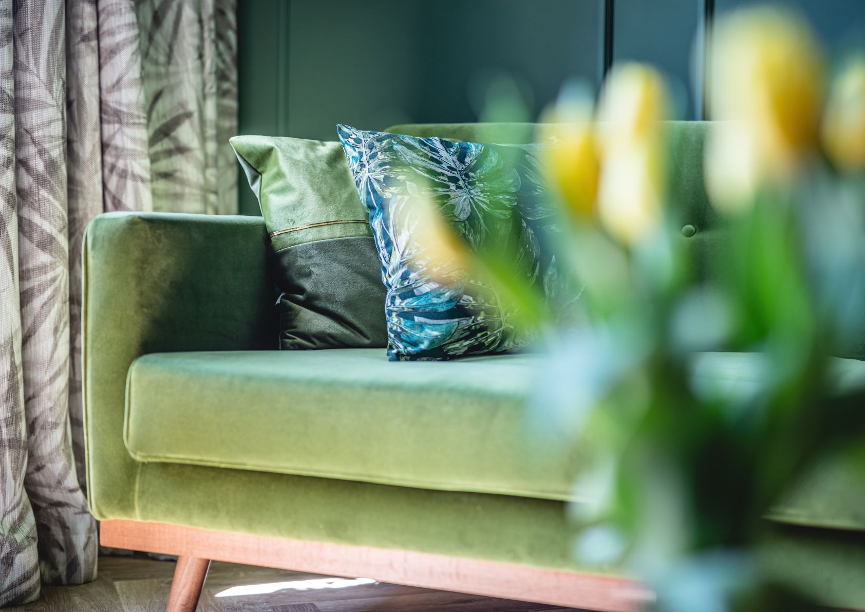 home with green couch and flowers. Staged and ready for spring. 