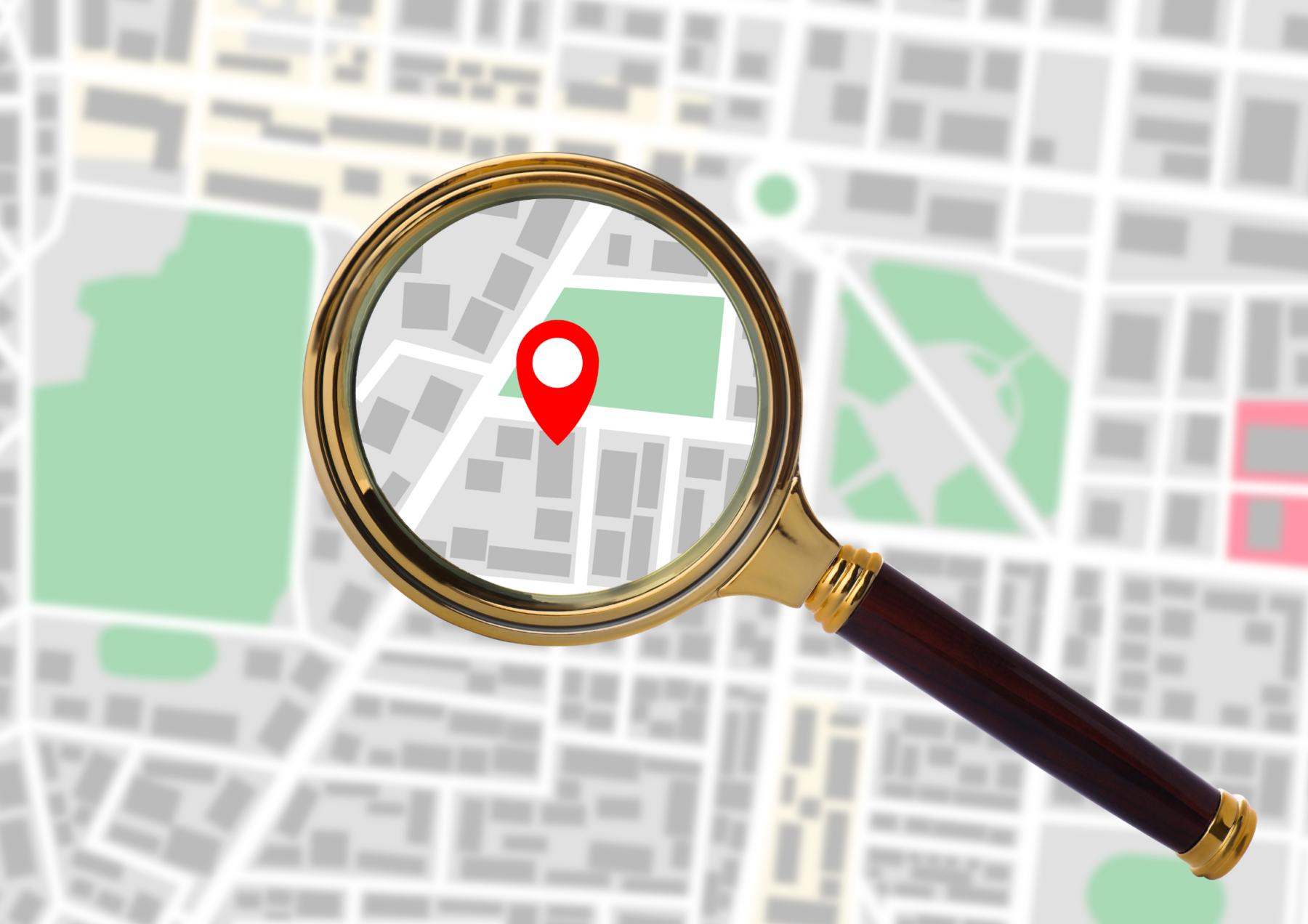 map with a magnifying glass reviling a pin. 